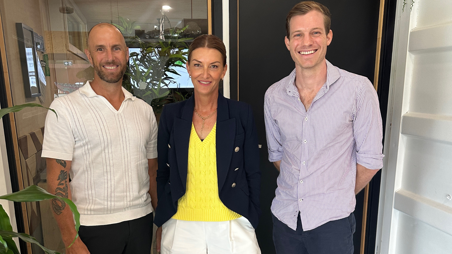 Franchise consultants meeting with their franchise client to discuss business strategies.