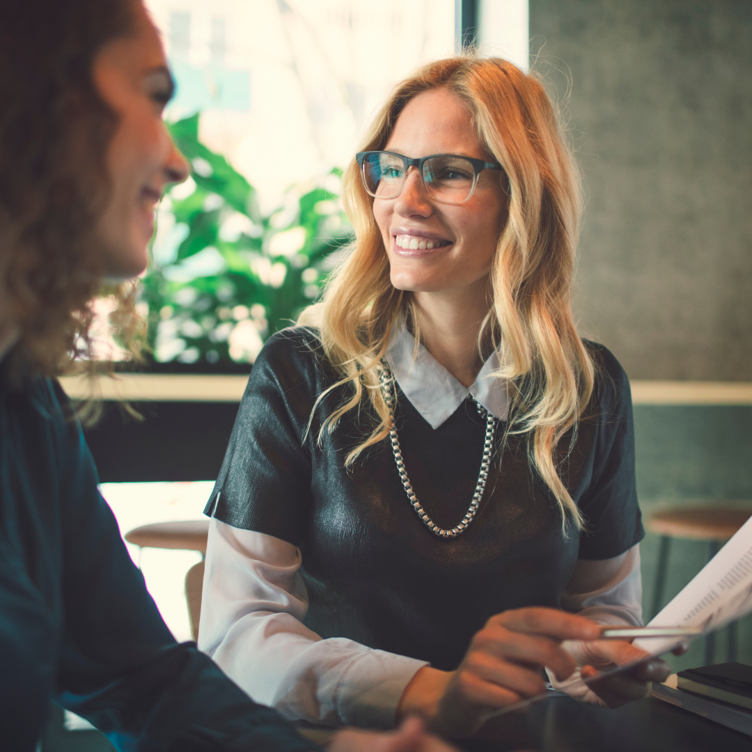 Franchise consultant discussing strategy with a client in a modern office setting.